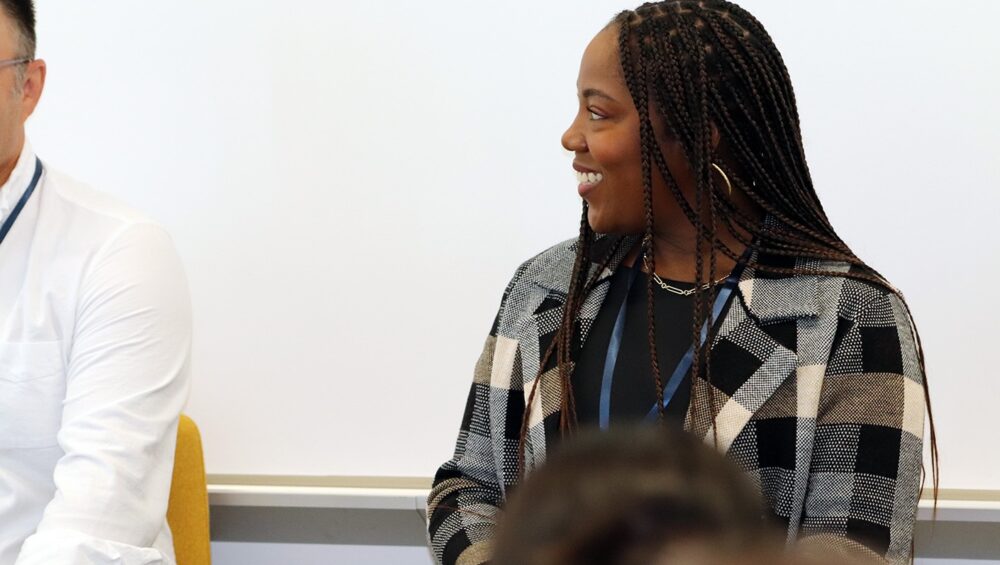 Session speaker listens to co-panelist