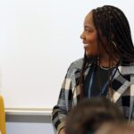 Session speaker listens to co-panelist