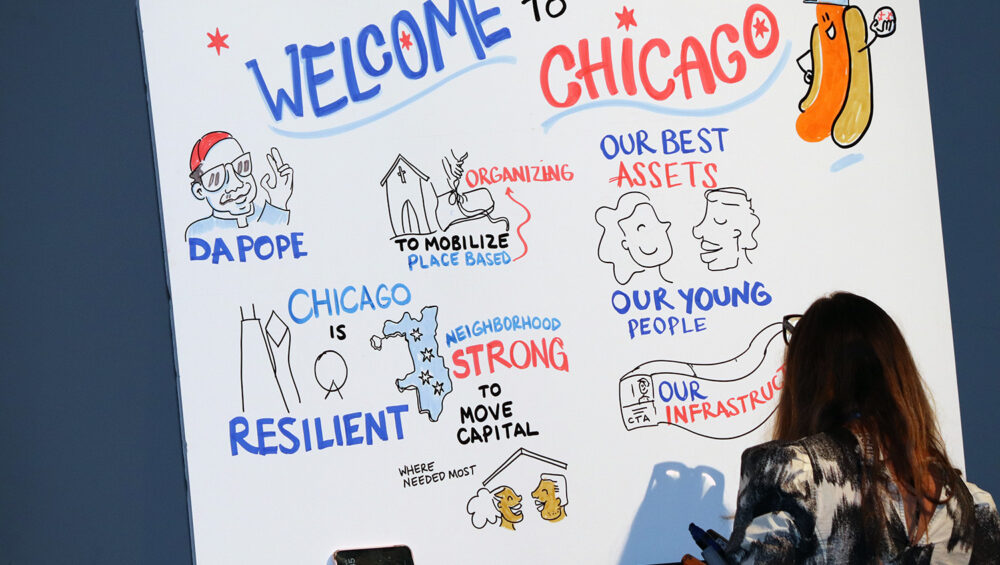 Live note-taking on stage at Neighborhood Economics Chicago 2025