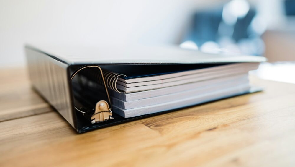 A binder on a wooden table
