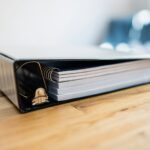 A binder on a wooden table